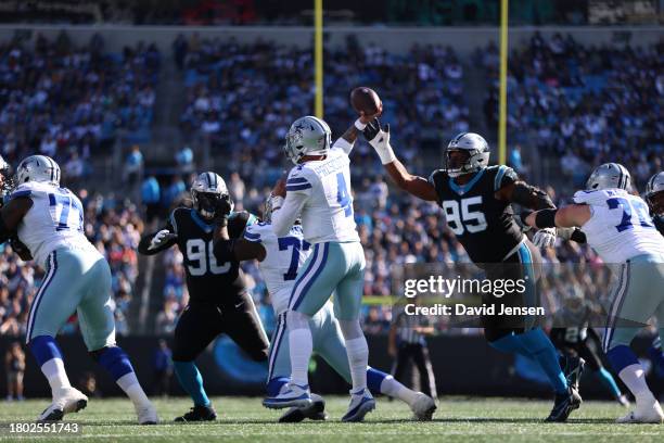 Dak Prescott of the Dallas Cowboys is rushed by Derrick Brown of the Carolina Panthers during the first quarter at Bank of America Stadium on...