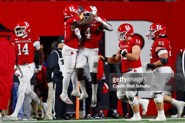 Running back Aaron Young of the Rutgers Scarlet Knights celebrates his touchdown with Kyle Monangai during the second quarter of a game against the...