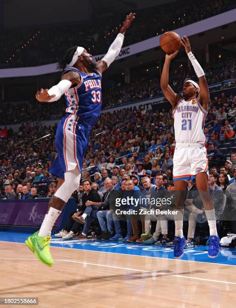 Aaron Wiggins of the Oklahoma City shoots a three point basket during the game against the Philadelphia 76ers on November 25, 2023 at Paycom Arena in...