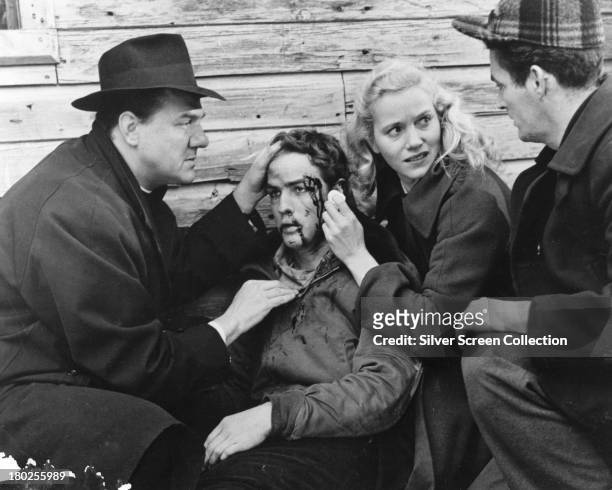 American actors Karl Malden , as Father Barry, Marlon Brando as Terry Malloy, Eva Marie Saint as Edie Doyle, and an unidentified actor, in 'On The...