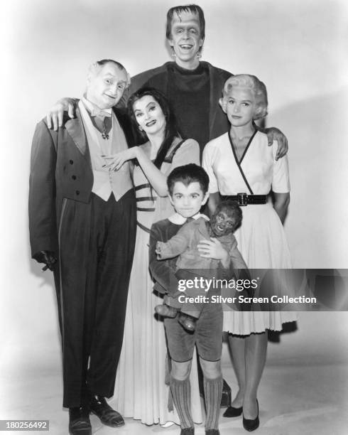 Members of the Munster family in a publicity still for season one of the comedy-horror TV series 'The Munsters', 1964. Left to right: Al Lewis as...