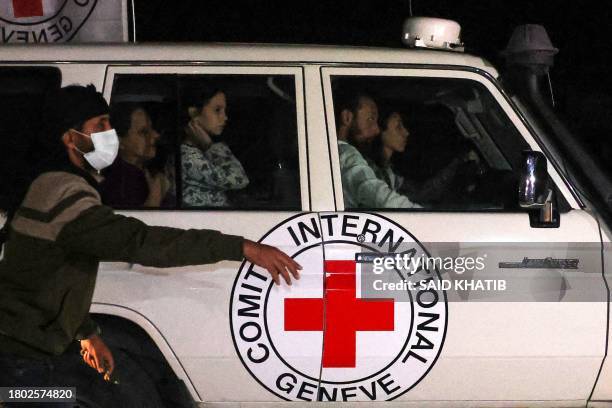 An International Red Cross vehicle carrying hostages released by Hamas drives towards the Rafah border point with Egypt ahead of their transfer to...