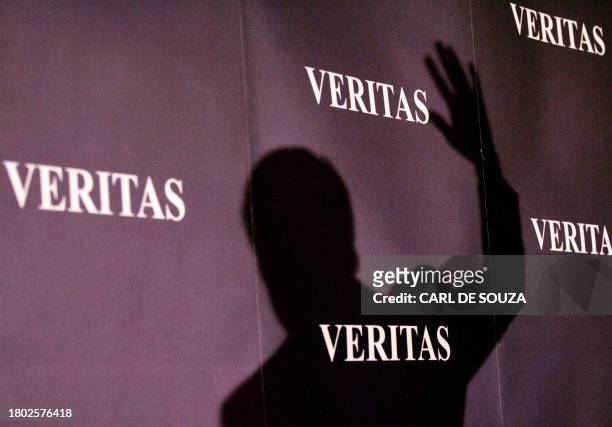 The shadow of former talk show host turned politician, now leader of "Veritas" Robert Kilroy-Silk is cast on the wall during the launch of his...