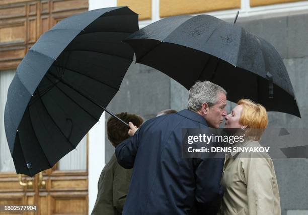 President George W. Bush kisses Ludmila Putin as Russian President Vladimir Putin greets Laura Bush before attending the military parade 09 May 3005...