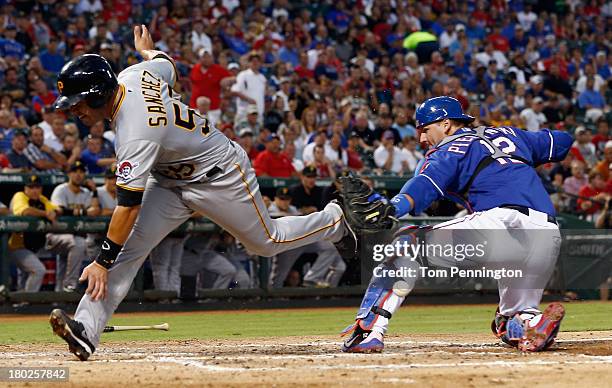 Pittsburgh Pirates catcher Tony Sanchez collides with Texas Rangers catcher A.J. Pierzynski against the Texas Rangers at the plate to score a run on...