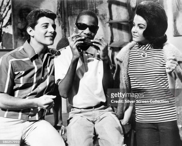Frankie Avalon, as Frankie, thirteen year-old singer-songwriter Stevie Wonder as himself, and Annette Funicello as Dee Dee, in 'Muscle Beach Party',...