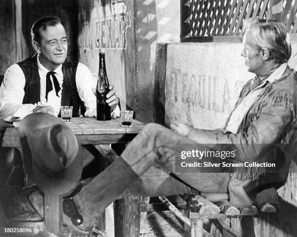 American actors John Wayne , as Davy Crockett, and Richard Widmark as Jim Bowie, in 'The Alamo', directed by Wayne, 1960.