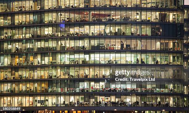 working late, financial district, london - building office foto e immagini stock