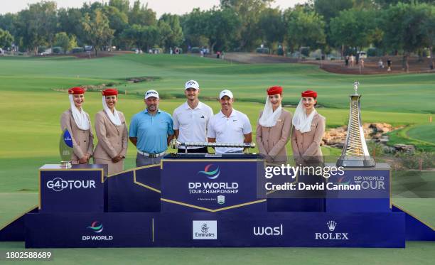 Nicolai Hojgaard of Denmark holds the DP World Tour Championship trophy with Rory McIlroy of Northern Ireland who won the DP World Tour Race to Dubai...