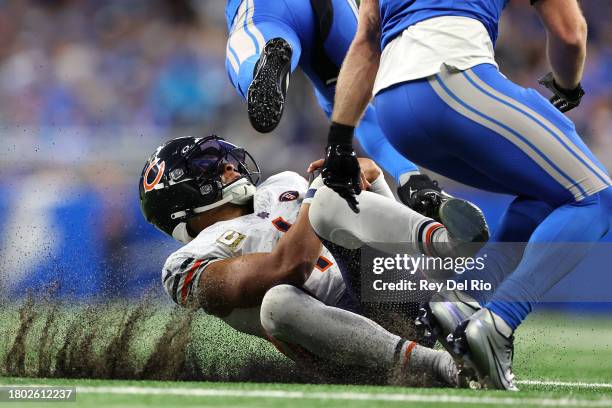 Justin Fields of the Chicago Bears] dives with the ball during the second quarter of a game against the Detroit Lions at Ford Field on November 19,...