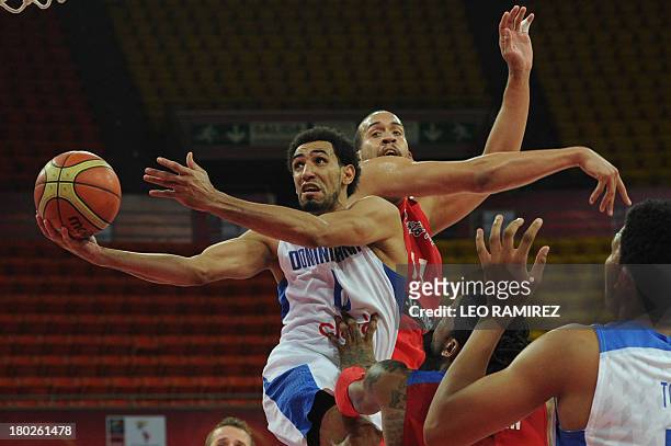 Dominican Republic Juan Coronado tries to score past Puerto Rican Ricardo Sanchez during their FIBA Championship game held in Caracas on September...