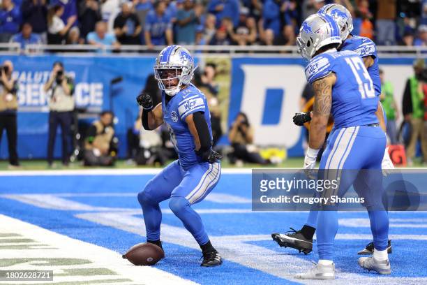 Amon-Ra St. Brown of the Detroit Lions celebrates a second quarter touchdown during a game against the Chicago Bears at Ford Field on November 19,...