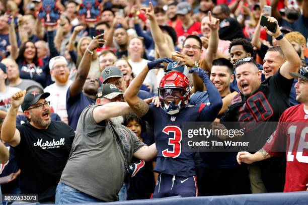 Tank Dell of the Houston Texans climbs into stands after a second quarter touchdown during a game against the Arizona Cardinals at NRG Stadium on...