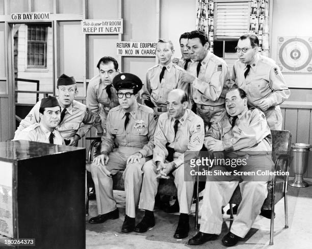 Sergeant Ernie Bilko, played by American comedian Phil Silvers watches television with his men in the US TV sitcom 'The Phil Silvers Show', circa,...