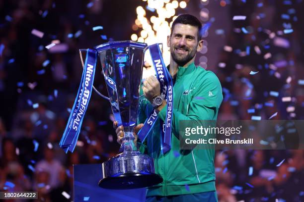 Novak Djokovic of Serbia celebrates with the Nitto ATP Finals trophy after victory against Jannik Sinner of Italy in the Men's Singles Finals between...