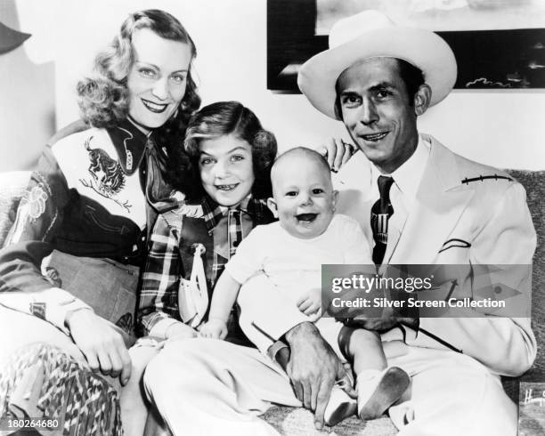 American country singer-songwriter Hank Williams with his family, in Nashville Tennessee, 1949. Left to right: musician Audrey Williams , her...