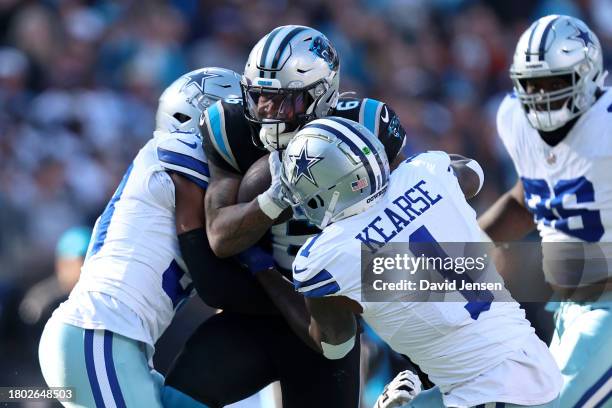 Miles Sanders of the Carolina Panthers is tackled by Jayron Kearse of the Dallas Cowboys during the second quarter at Bank of America Stadium on...