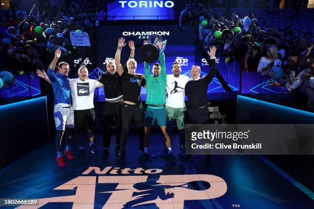 Novak Djokovic of Serbia lifts the Nitto ATP Finals trophy with their team after victory against Jannik Sinner of Italy in the Men's Singles Finals...