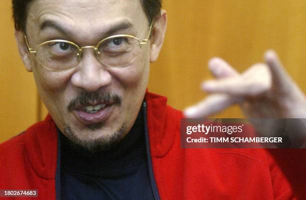 Former Malaysian deputy prime minister Anwar Ibrahim gestures as he speaks to journalists in his room at the Alpha Clinic in Munich 20 September...