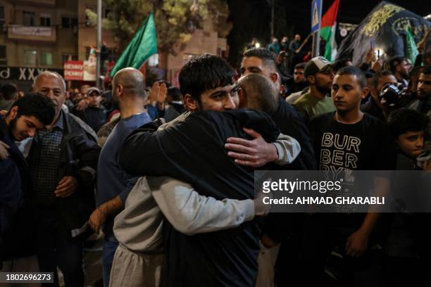 Palestinian prisoner is welcomed by a relative after being released from Israeli jails in exchange for hostages released by Hamas from the Gaza...