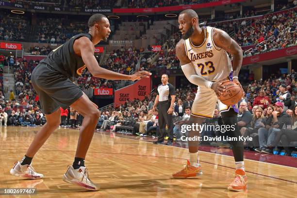 LeBron James of the Los Angeles Lakers handles the ball during the game against the Cleveland Cavaliers on November 25, 2023 at Rocket Mortgage...