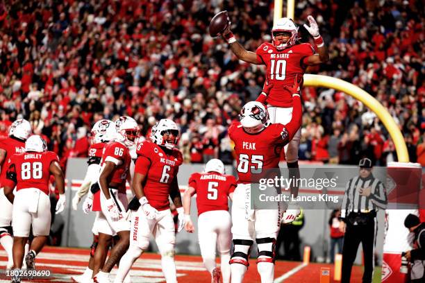 Kevin Concepcion celebrates his touchdown with Jacarrius Peak of the NC State Wolfpack during the first half of the game against the North Carolina...