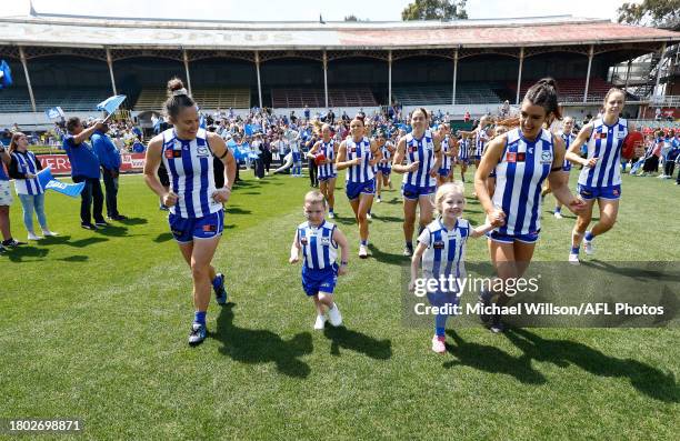 The Kangaroos run onto the field during the 2023 AFLW Second Preliminary Final match between The North Melbourne Tasmanian Kangaroos and The Adelaide...