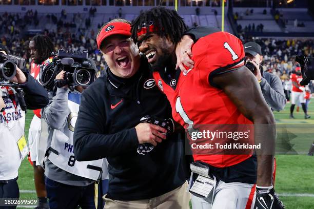 Head coach Kirby Smart of the Georgia Bulldogs reacts with Marcus Rosemy-Jacksaint following the 31-23 victory over the Georgia Tech Yellow Jackets...