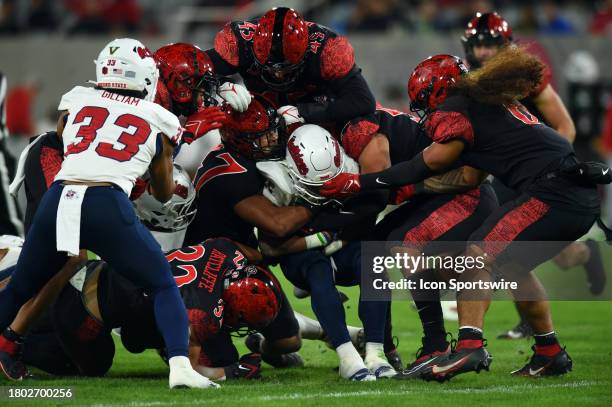 Fresno State running back Malik Sherrod is taken down by several San Diego State defenders at the end of a run during a college football game between...