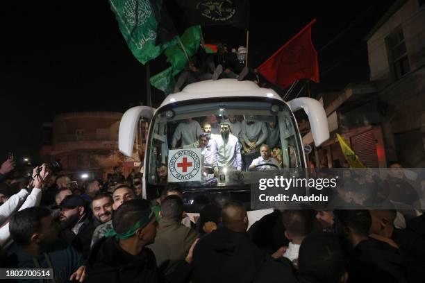 Palestinians, brought by International Committee of the Red Cross vehicle, reunite with their relatives as they are released from Israeli Ofer prison...