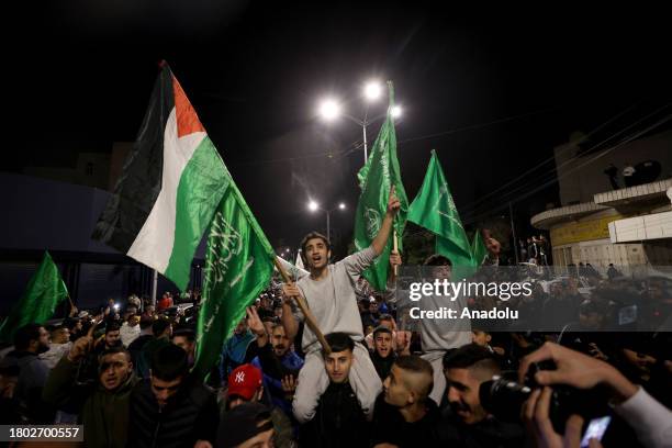 Palestinians, brought by International Committee of the Red Cross vehicle, reunite with their relatives as they are released from Israeli Ofer prison...