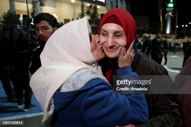 Palestinians, brought by International Committee of the Red Cross vehicle, reunite with their relatives as they are released from Israeli Ofer prison...