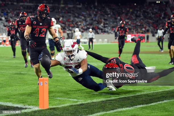 Fresno State running back Elijah Gilliam runs the ball towards the pylon and stretches towards it in an attempt to score a touchdown during a college...