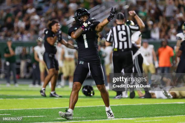 Peter Manuma of the Hawaii Rainbow Warriors gestures to the fans after holding the Colorado State Rams on fourth down during the second half of their...