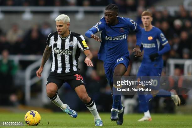 Bruno Guimaraes of Newcastle United is being pressured by Chelsea's Lesley Ugochukwu during the Premier League match between Newcastle United and...