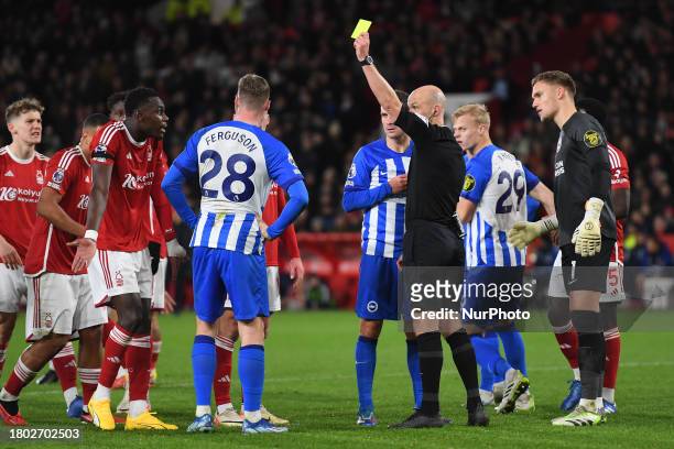 Referee Anthony Taylor is showing yellow cards to Moussa Niakhate of Nottingham Forest and Evan Ferguson of Brighton during the Premier League match...