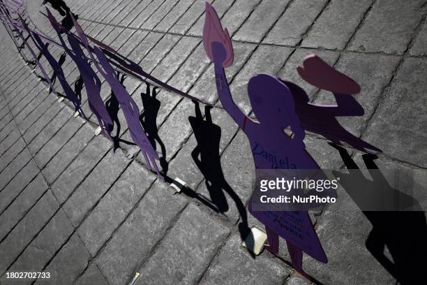 Wooden silhouettes of women are being viewed at the Angel of Independence in Mexico City, on the occasion of the International Day for the...