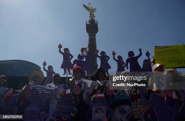 Mothers of missing daughters and victims of feminicide and sexist violence are demonstrating with photographs and banners at the Angel of...