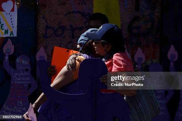 Mothers of missing daughters, victims of feminicide and sexist violence, are hugging under the Angel of Independence in Mexico City on the occasion...