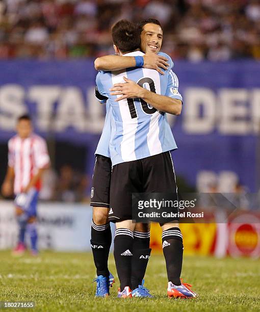 Maxi Rodriguez and Lionel Messi celebrate after Maxi Rodriguez scored the fifth goal during a match between Paraguay and Argentina as part of the...