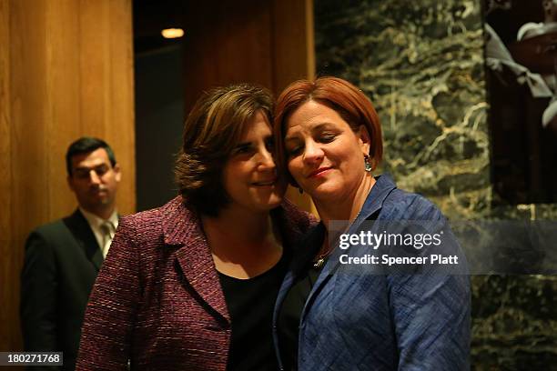 New York City Council Speaker Christine Quinn stands backstage with her wife Kim Catullo moments before conceding defeat in the New York Democratic...