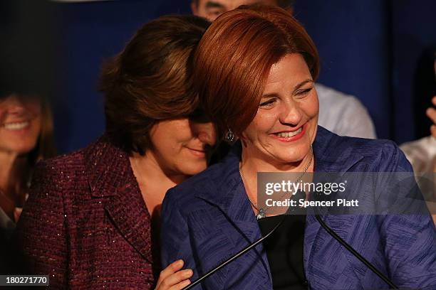 New York City Council Speaker Christine Quinn speaks next to her wife Kim Catullo during her concession speech in the New York Democratic mayoral...