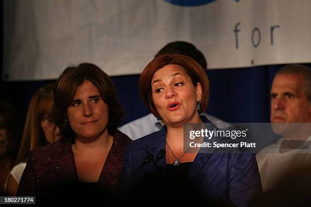 New York City Council Speaker Christine Quinn speaks next to her wife Kim Catullo during her concession speech in the New York Democratic mayoral...