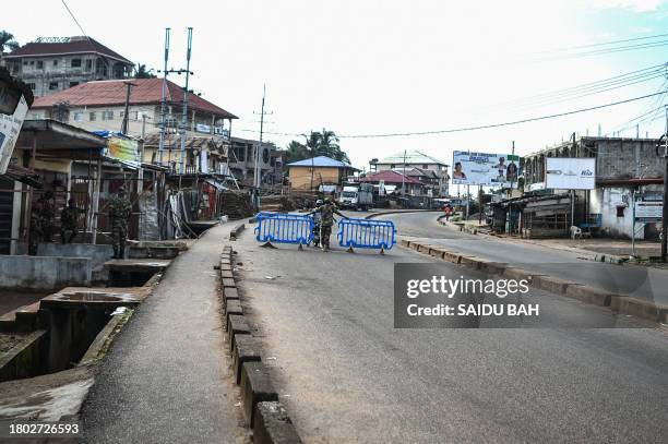 Man is questioned by Sierra leonean military police at a road block in Freetown on November 26, 2023. A military armoury in Sierra Leone's capital...