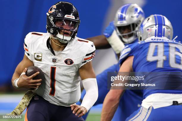 Justin Fields of the Chicago Bears runs with the ball during the fourth quarter of a game against the Detroit Lions at Ford Field on November 19,...