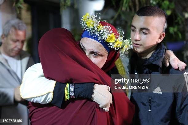 Relatives of prominent Palestinian prisoner Israa Jaabis welcome her at her home in Israeli-annexed east Jerusalem early on November 26 after...