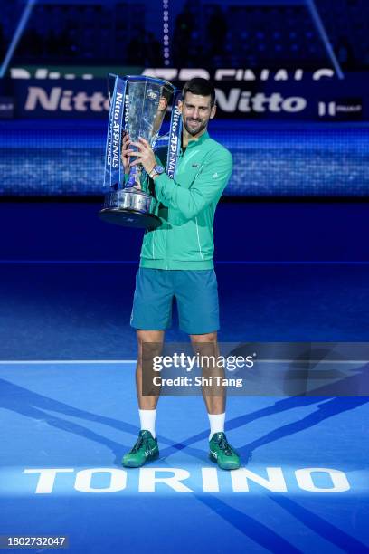 Novak Djokovic of Serbia poses for a photo with Nitto ATP Finals trophy after the Men's Singles Final match against Jannik Sinner of Italy during day...