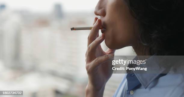 asian man smokes cigarette - myocarditis stock pictures, royalty-free photos & images