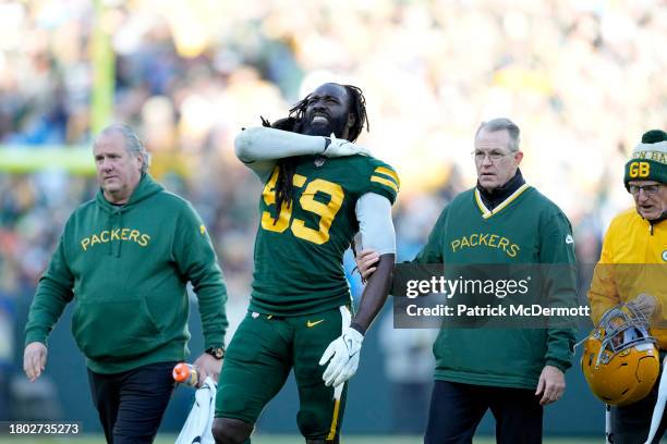 De'Vondre Campbell of the Green Bay Packers is attended to after being injured in the fourth quarter against the Los Angeles Chargers at Lambeau...