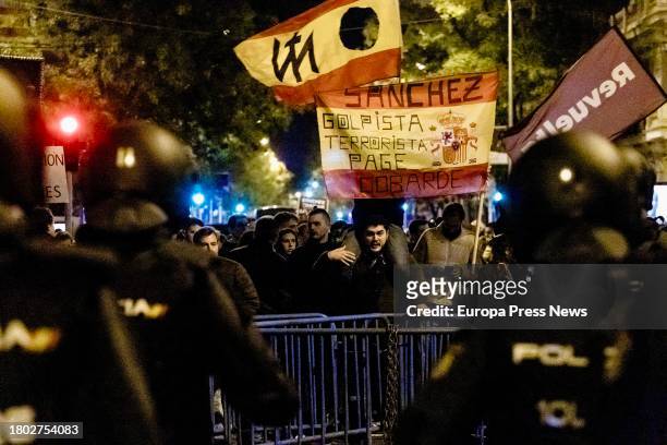 Demonstrators clash with police during a demonstration against the amnesty in front of the PSOE headquarters in Ferraz, on 19 November, 2023 in...